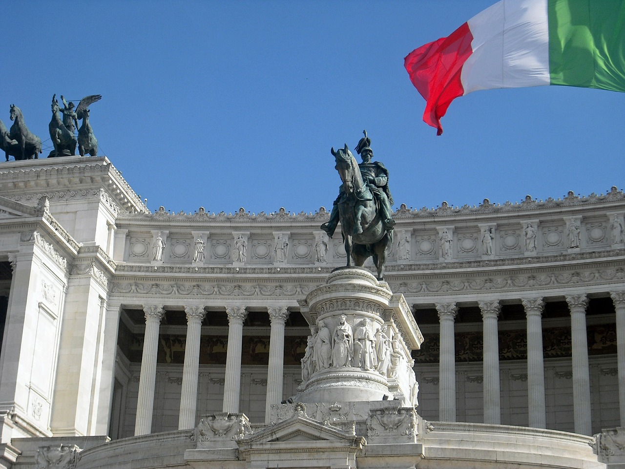 statues and the italian flag in Rome