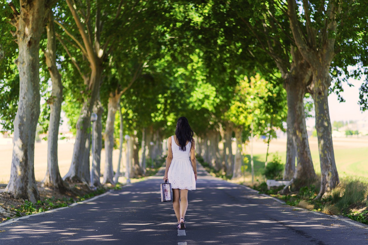 Women has packed essentials in her suitcase for her Autumn trip to villas in Italy 