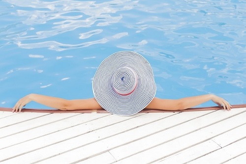 woman relaxing in a pool at our luxury villas in Puglia