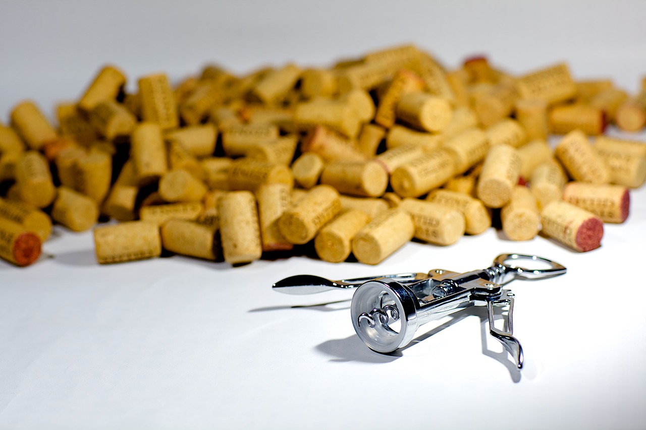 pile of Italian wine corks and a silver corkscrew