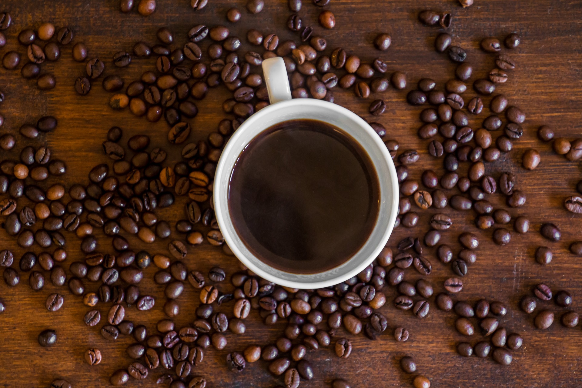 Italian cup of coffee with coffee beans.