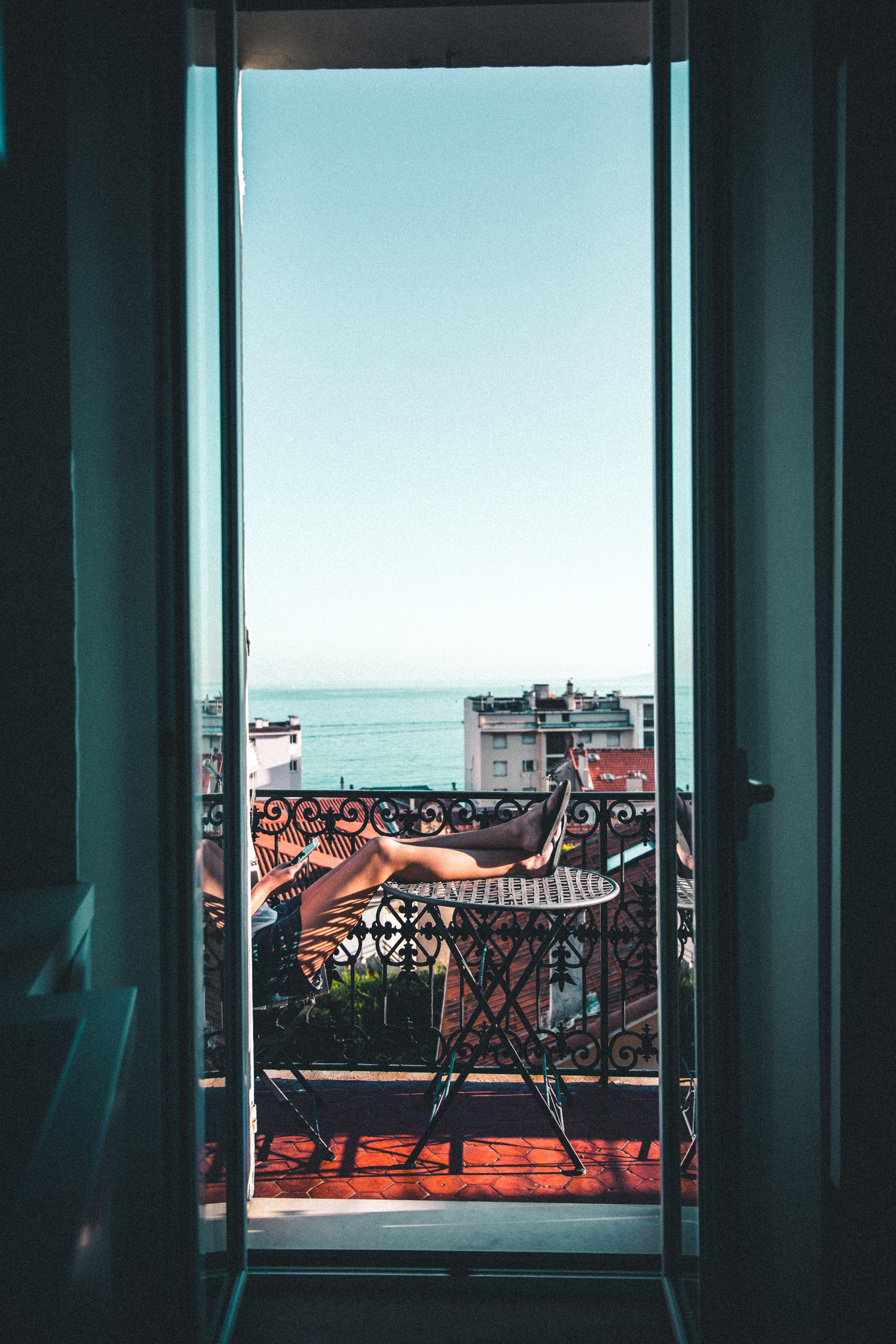 Woman relaxing on a balcony with a book  