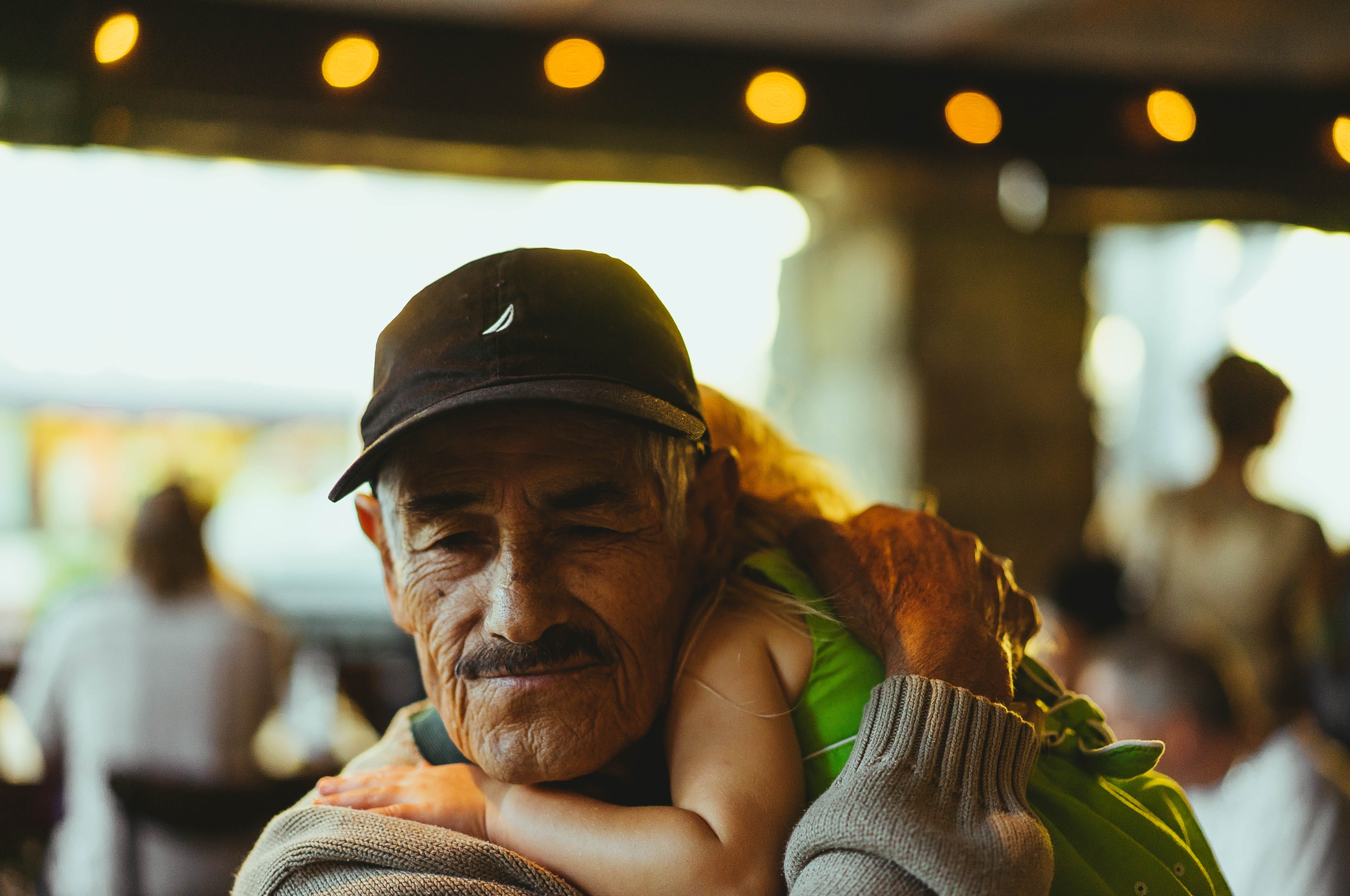 A smiling Grandparent with his Granddaughter 