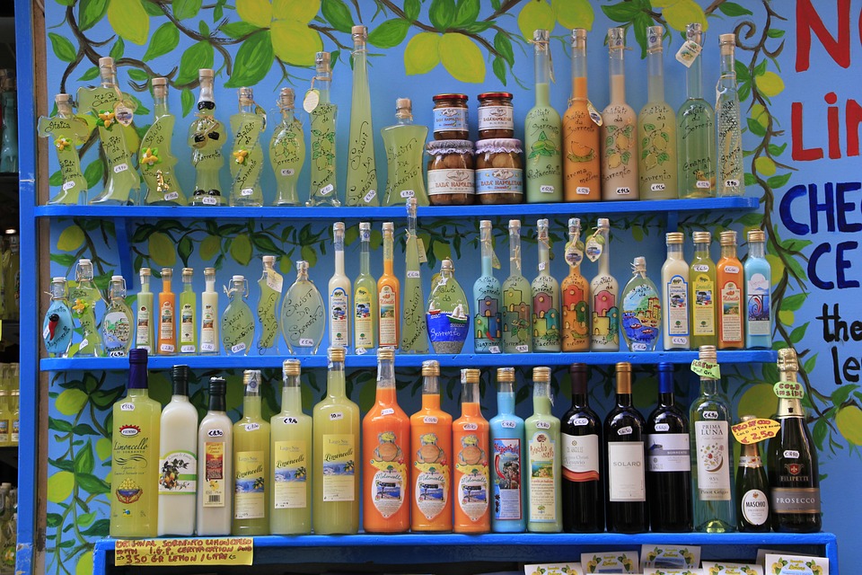 A colourful shelf full of Italian drinks, including Limoncello