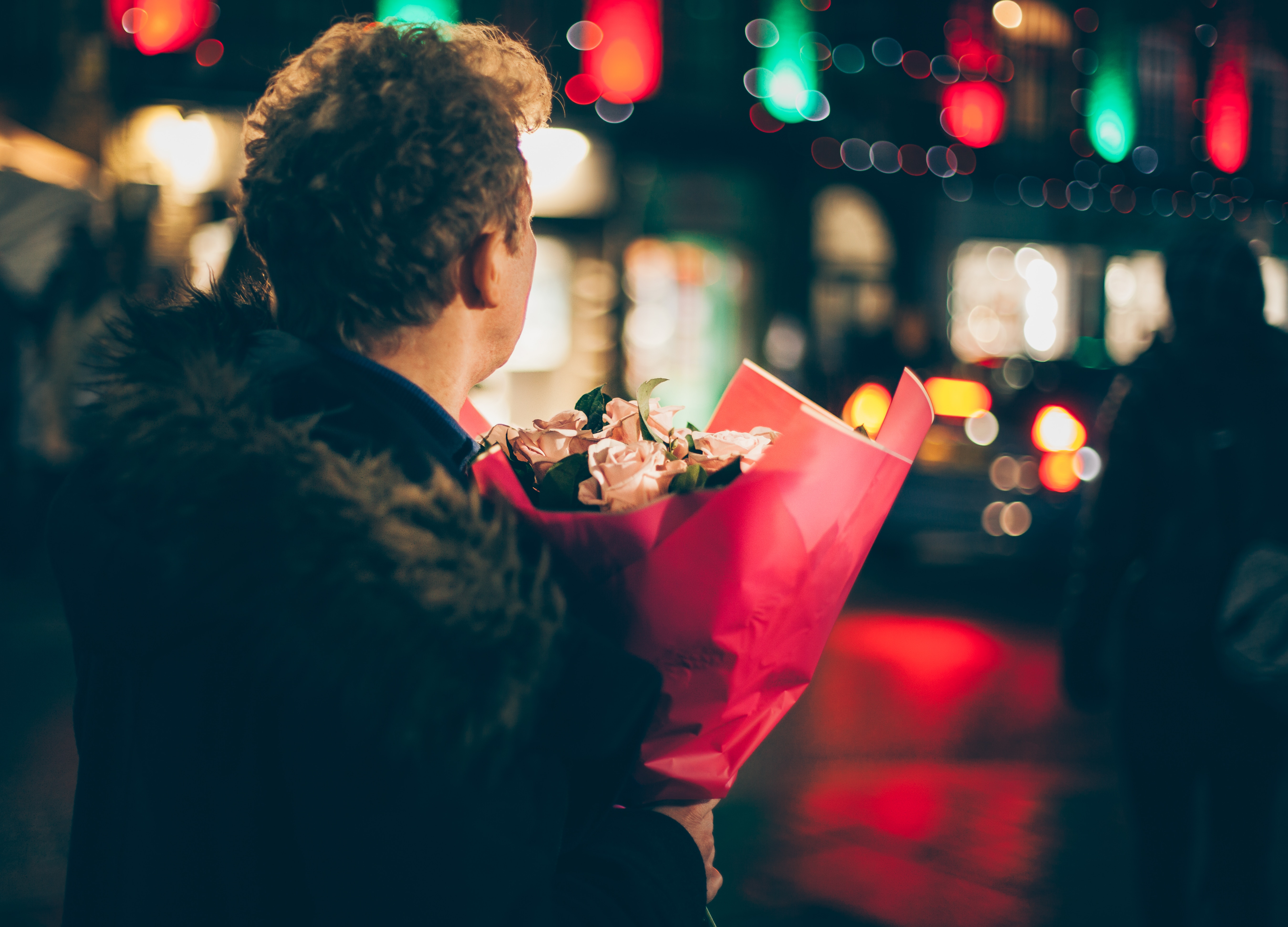 A man holding some roses for Valentine's Day 