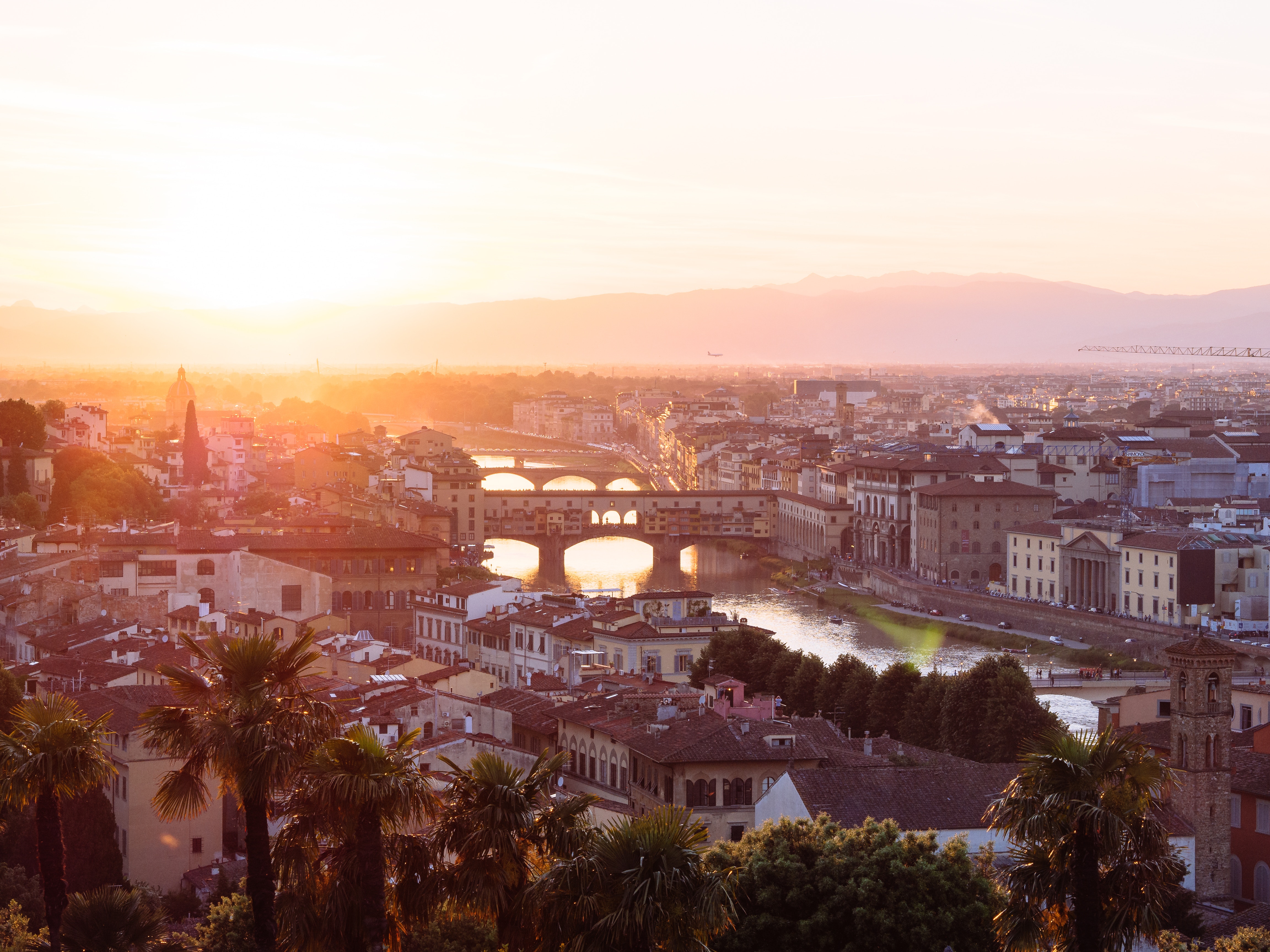 The sun sets over the bridges of the River Arno in the city of Florence, Tuscany