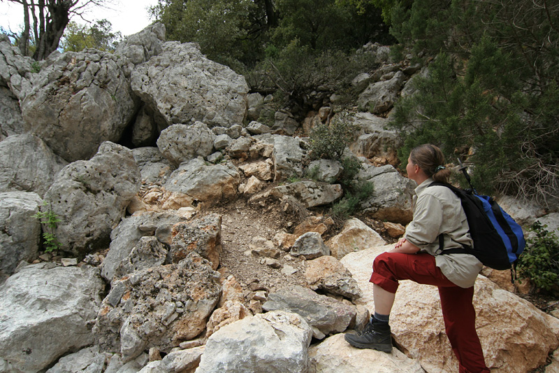 A woman hiking to Tiscali in Sardinia