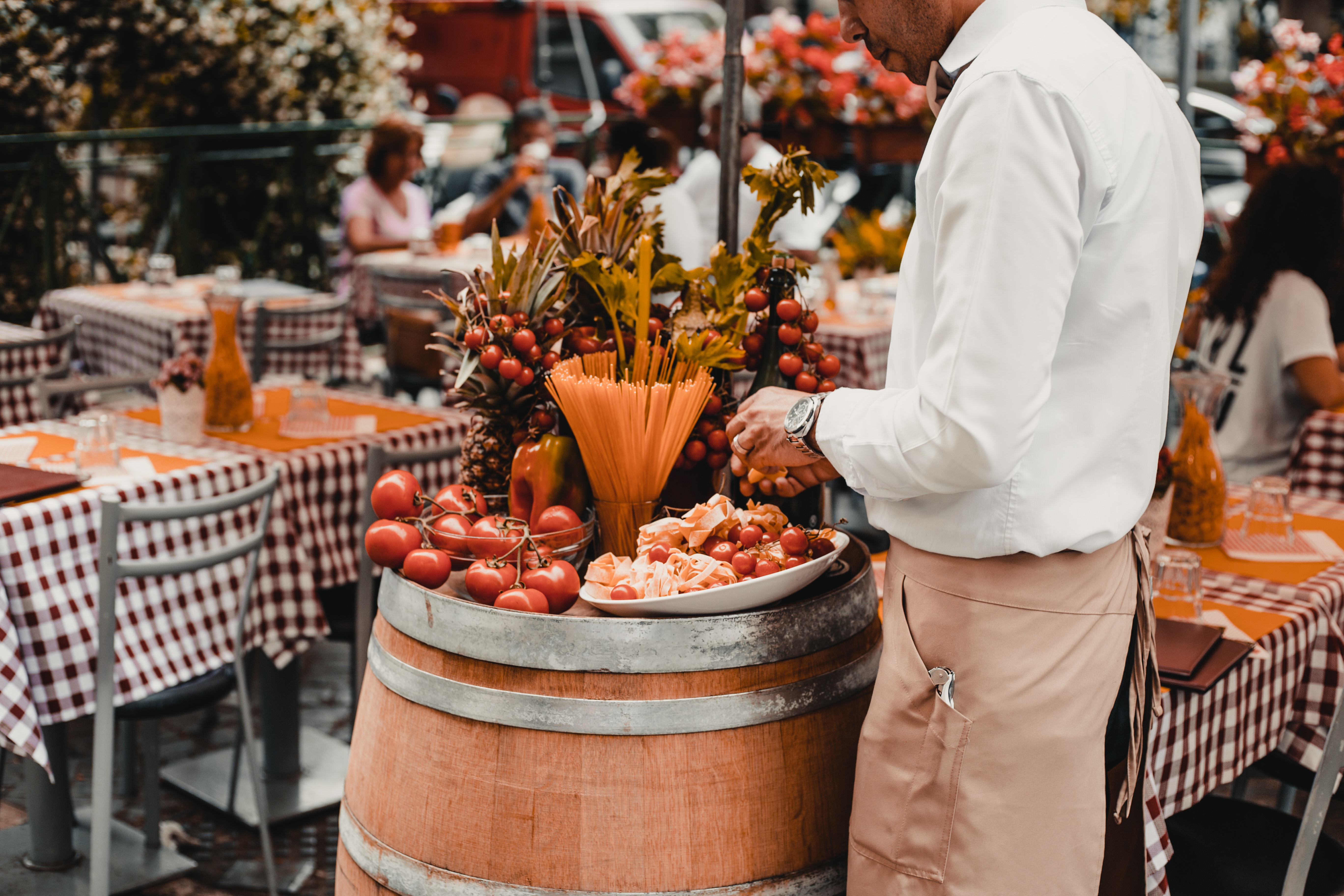 Italian waiter prepares food for diners at an Italian restaurant. 