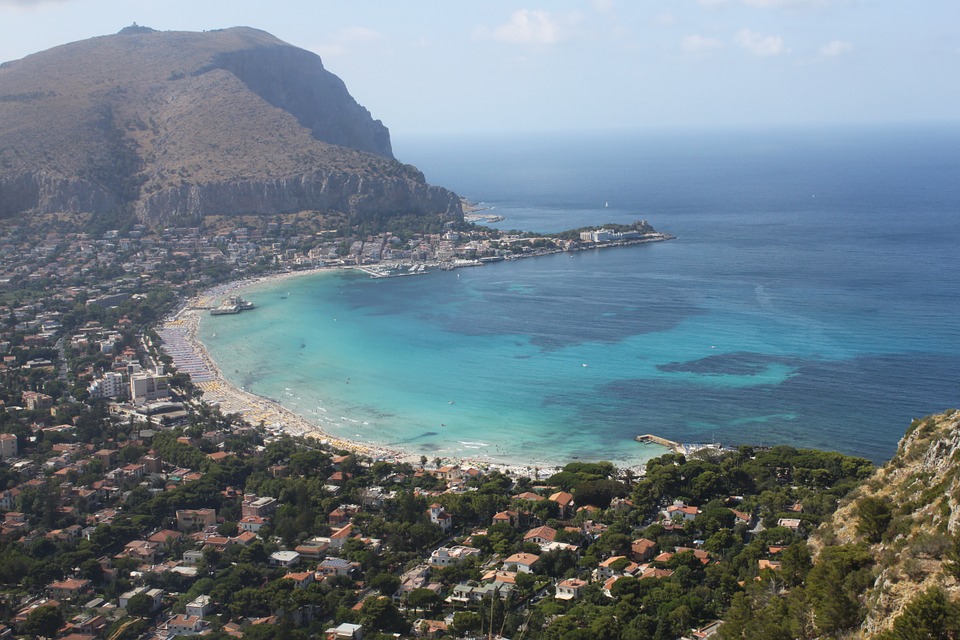 A beach in Palermo surrounded by hills and mountains