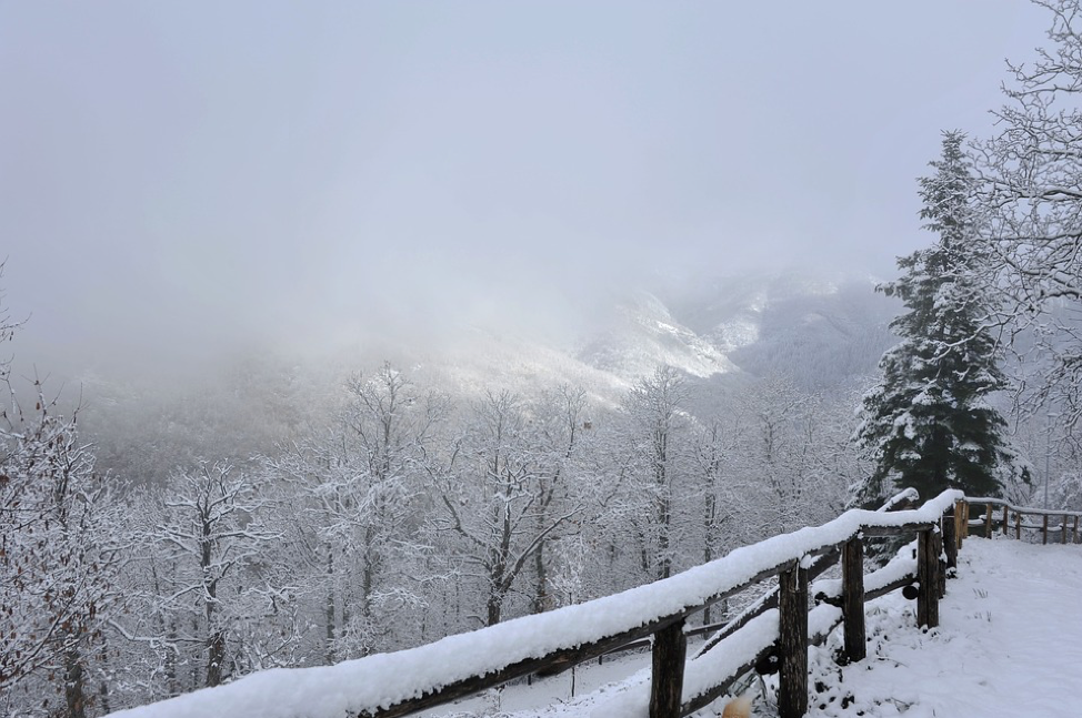 A snowy valley surrounded by mist in Tuscany