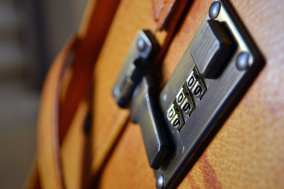 A black lock on a leather suitcase