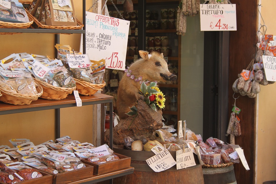 An Umbria storefront with a pig and meats