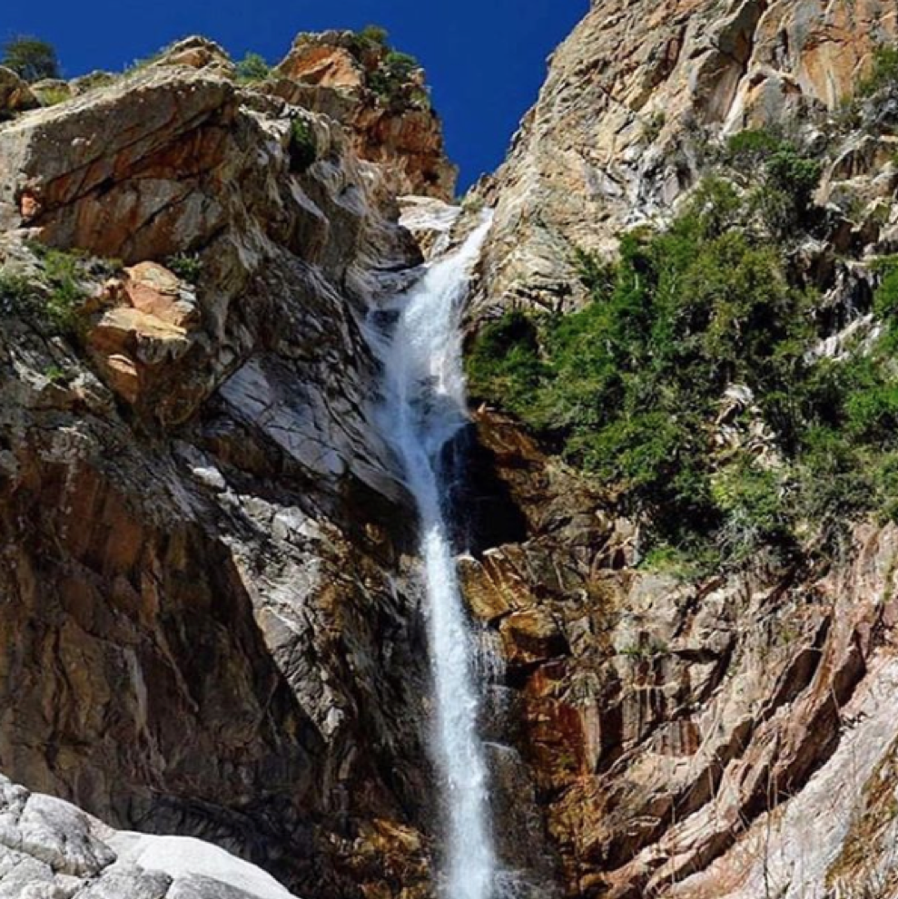 A large waterfall over a rocky cliff