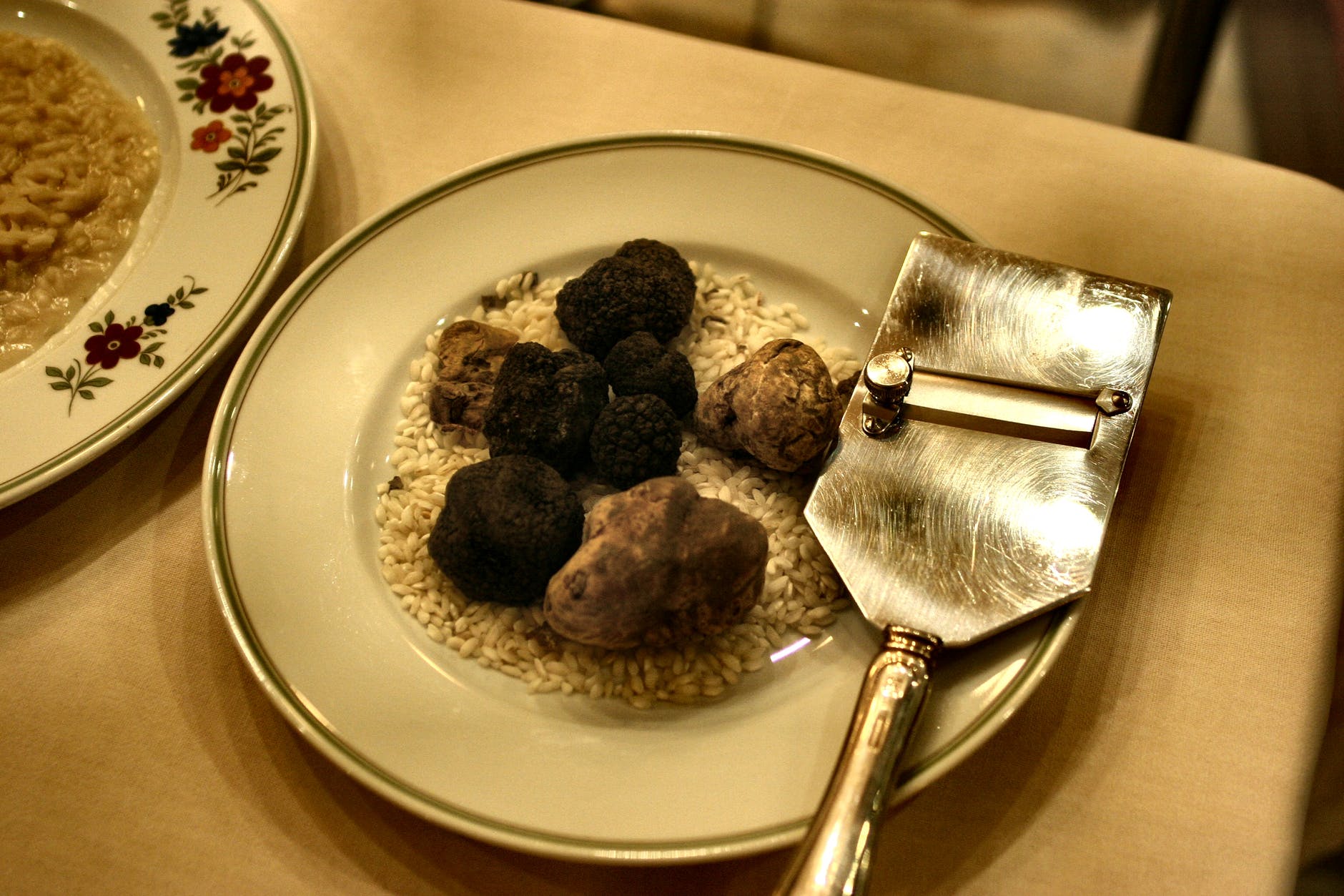 White and black truffles on a dish being served in a restaurant in Italy