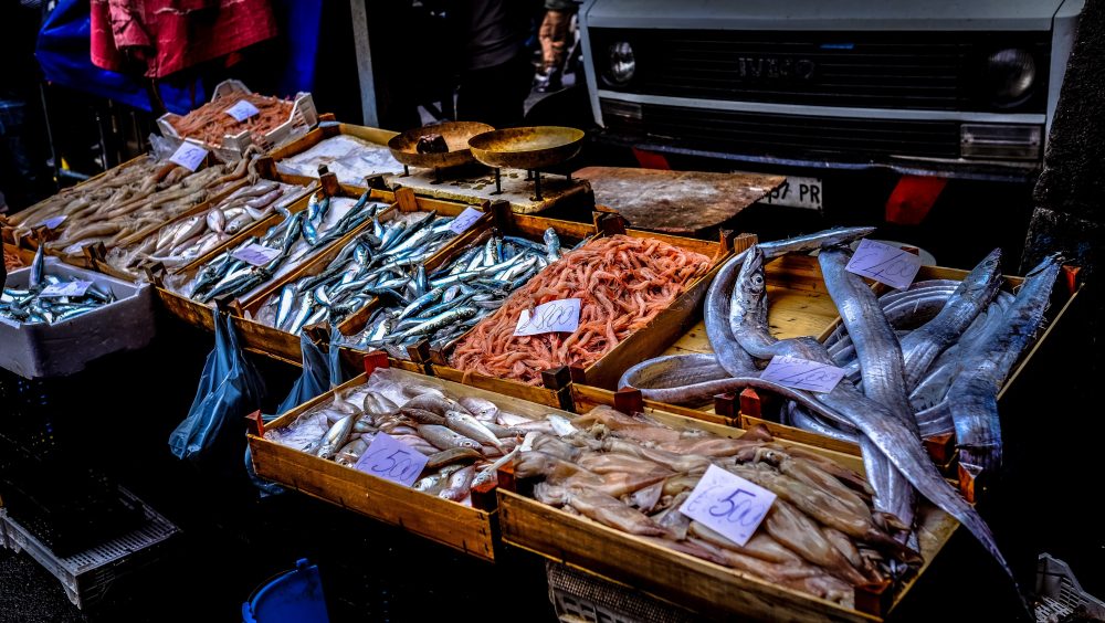 Table at a fish market with a selection of fish. 