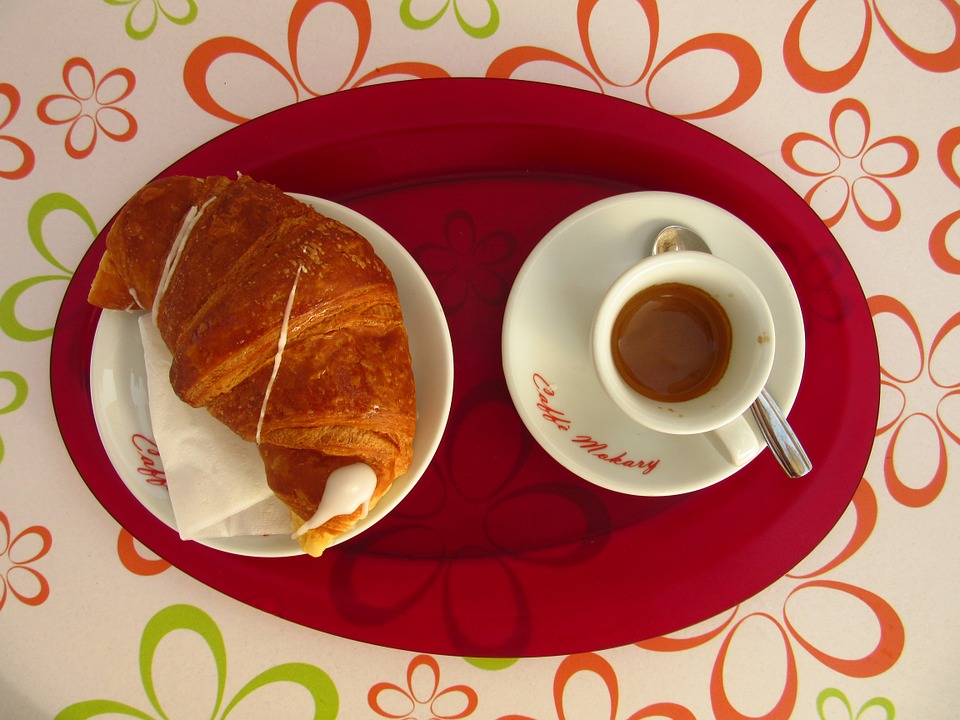 A croissant and coffee for breakfast in Italy