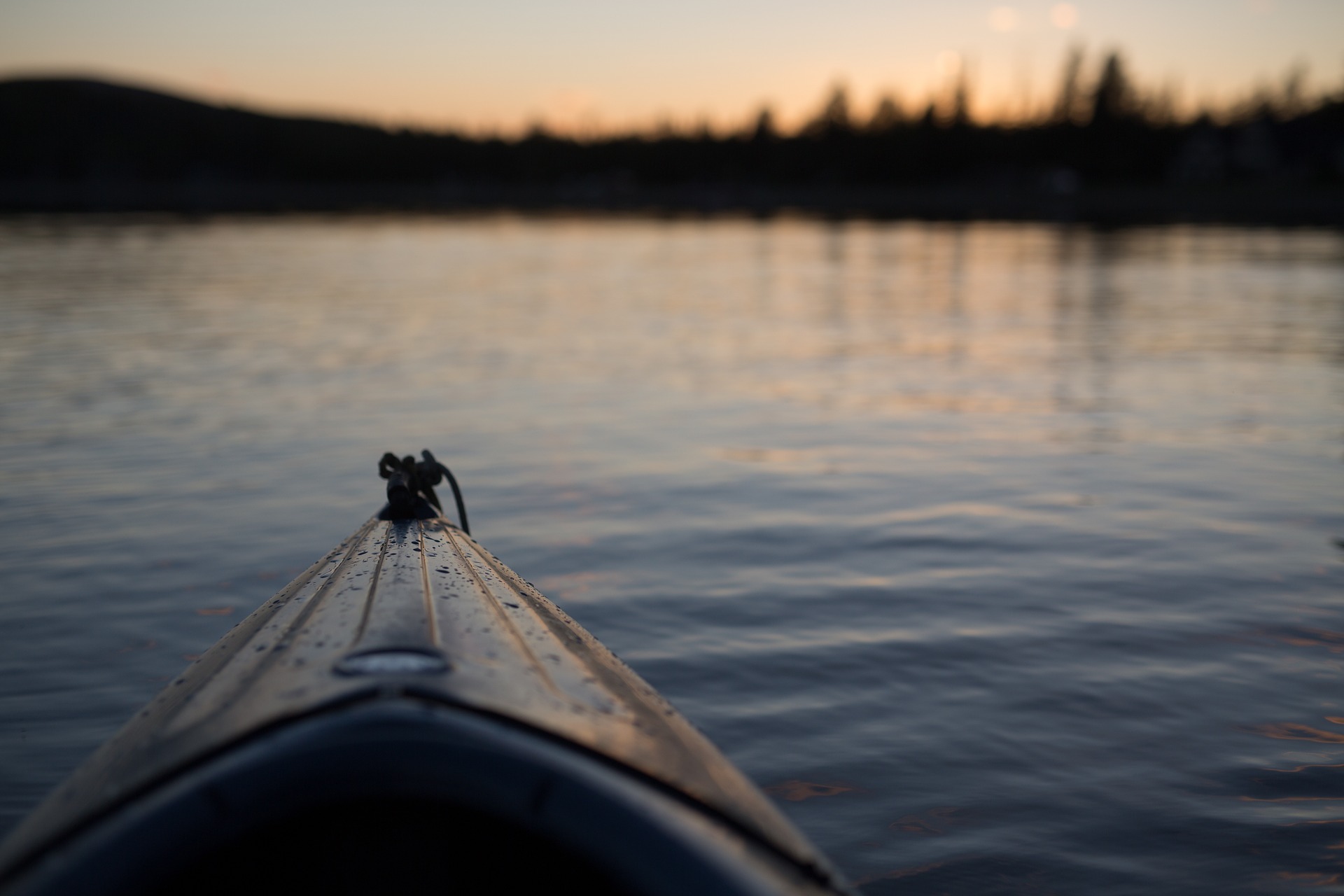 Front of canoe boat in water.