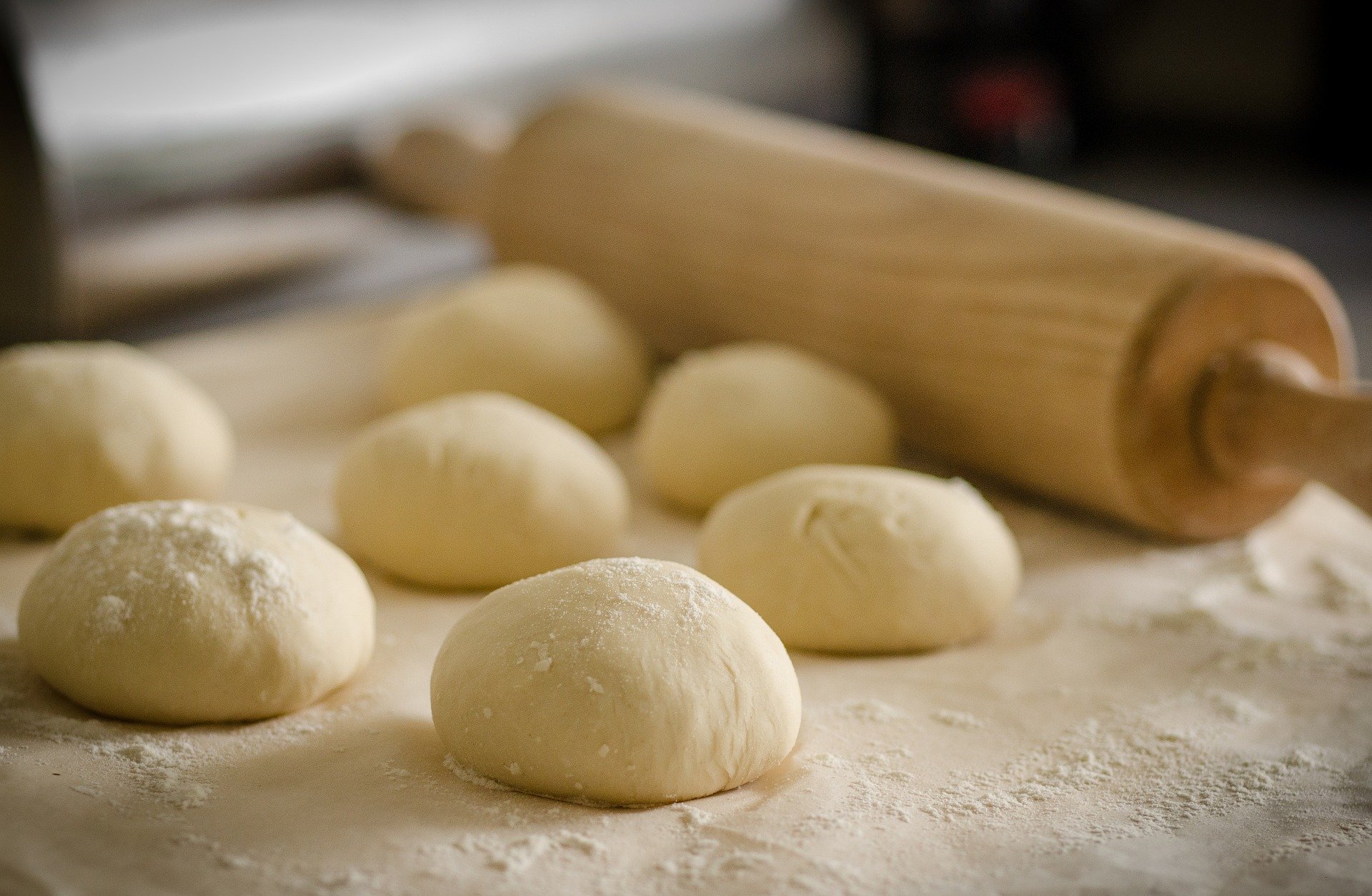 a picture of balls of dough and rolling pin 