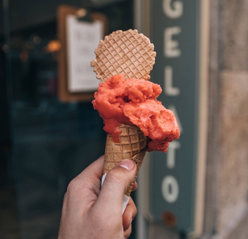 hand holding orange italian gelato